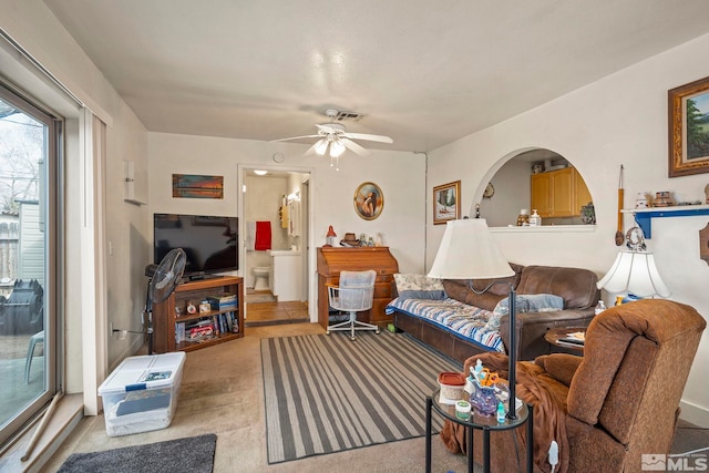 carpeted living area featuring visible vents and ceiling fan