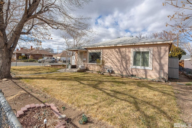 rear view of house with a yard