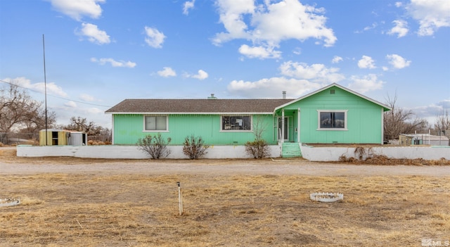 ranch-style house with an outbuilding and a storage shed