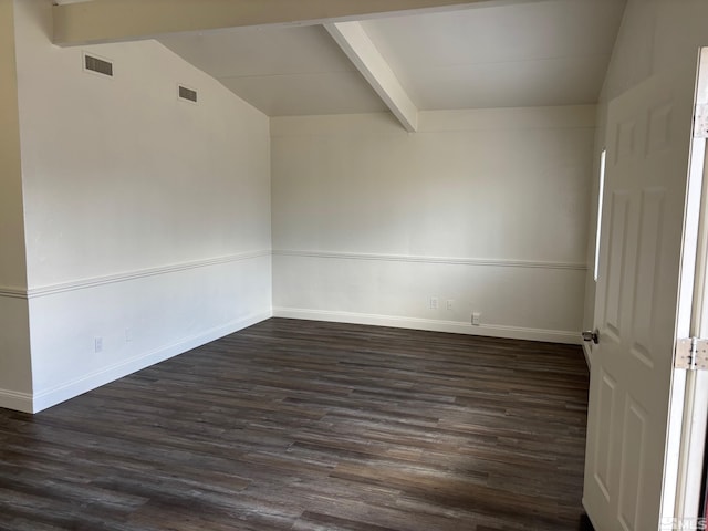 empty room featuring vaulted ceiling with beams, visible vents, and dark wood-type flooring