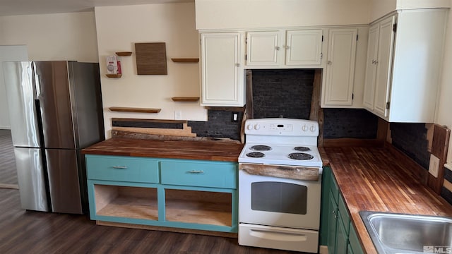 kitchen with dark wood finished floors, electric range, freestanding refrigerator, white cabinets, and wood counters