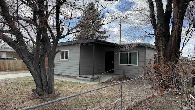 view of front of home featuring fence