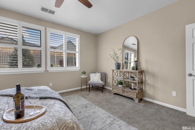 carpeted bedroom featuring ceiling fan, visible vents, and baseboards