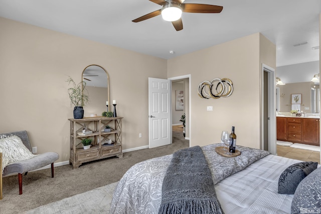 bedroom with light carpet, visible vents, baseboards, connected bathroom, and ceiling fan