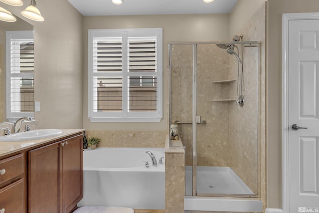 bathroom featuring vanity, a shower stall, and a bath