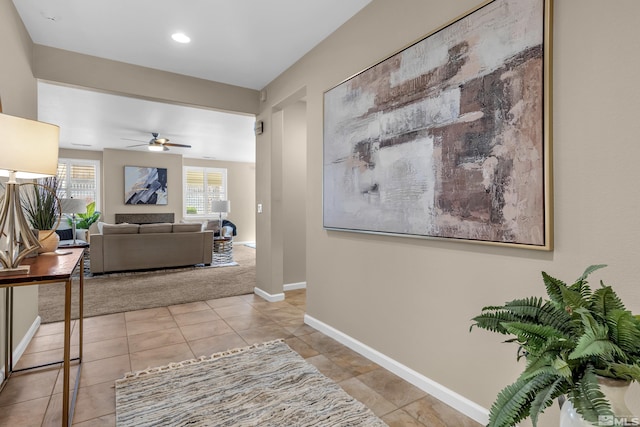 hall with light tile patterned floors, recessed lighting, and baseboards