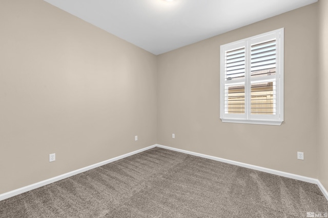 carpeted empty room with baseboards