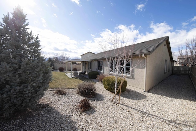 back of house with a patio, a fenced backyard, and stucco siding