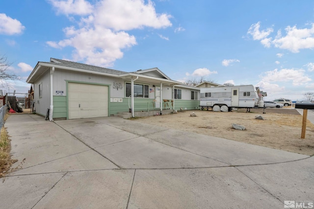 single story home featuring covered porch, driveway, and an attached garage