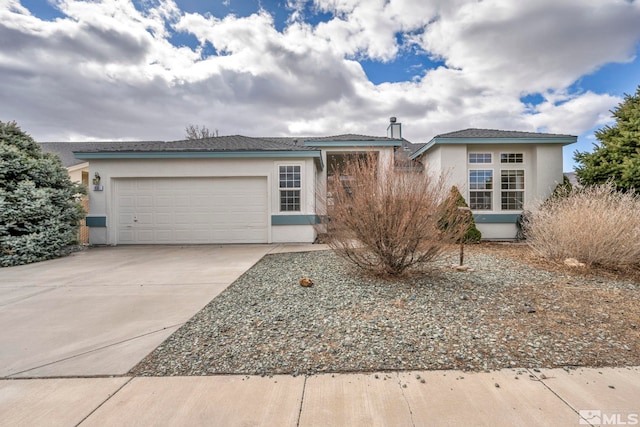 ranch-style home featuring a garage, driveway, and stucco siding