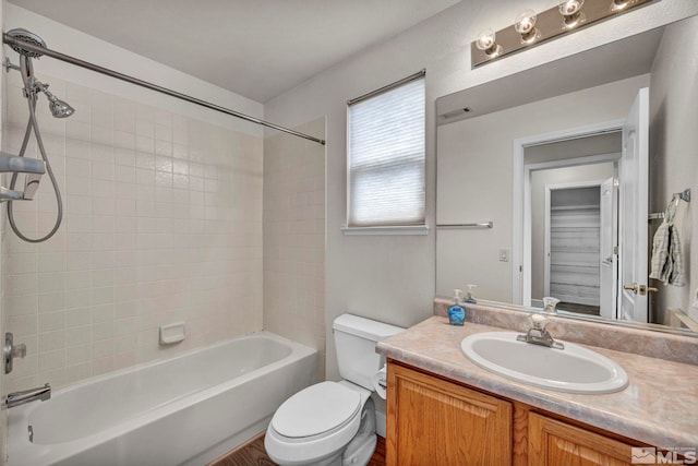 bathroom with toilet, bathing tub / shower combination, visible vents, and vanity