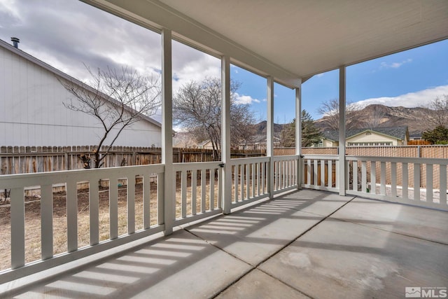 unfurnished sunroom featuring a mountain view