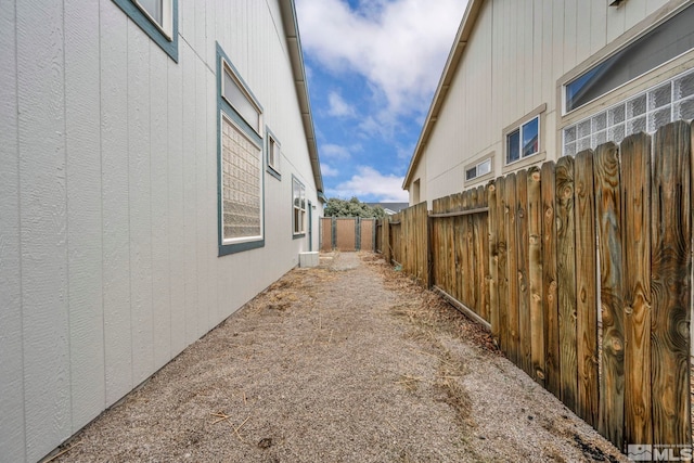 view of side of home featuring fence