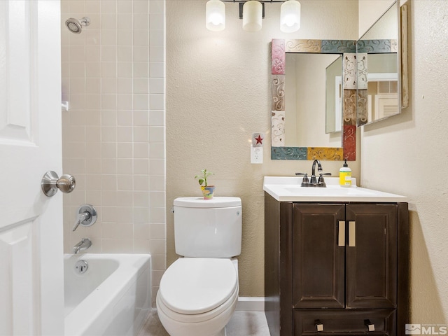 full bath with a textured wall, shower / bath combination, vanity, and toilet