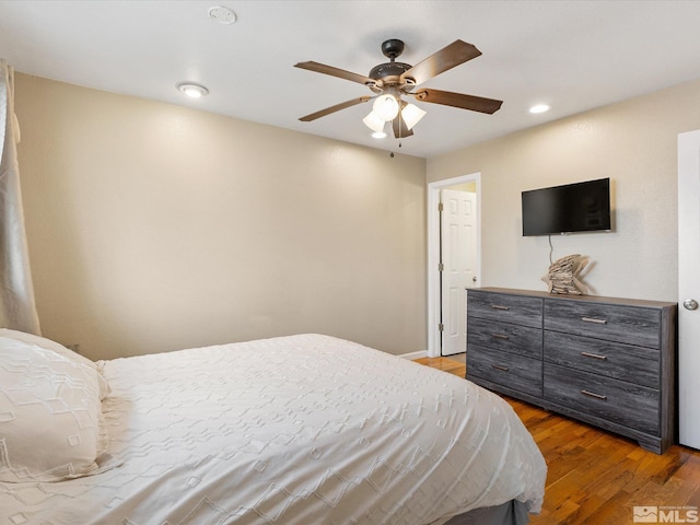 bedroom with ceiling fan, wood finished floors, and recessed lighting