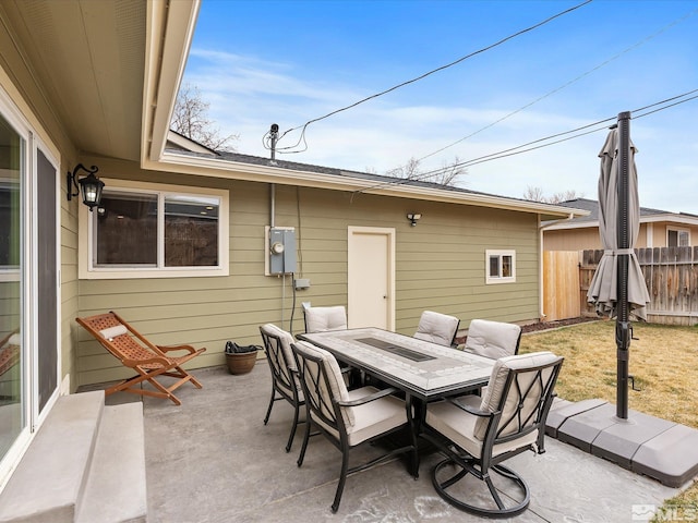 view of patio with outdoor dining space and fence