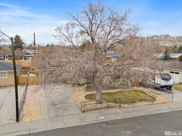 view of front of property with fence and driveway