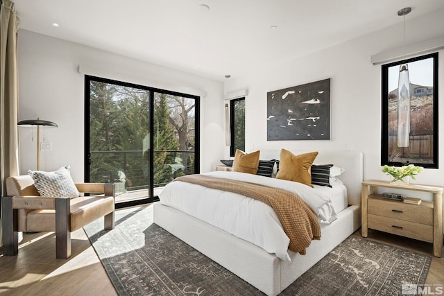 bedroom featuring wood finished floors and access to exterior