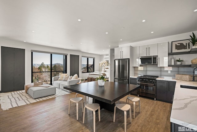 dining area with light wood-style floors and recessed lighting