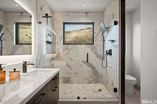 full bathroom with toilet, vanity, and a marble finish shower