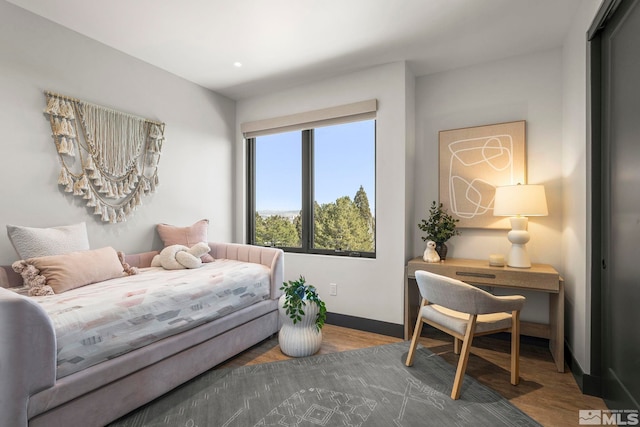 bedroom with recessed lighting, wood finished floors, and baseboards