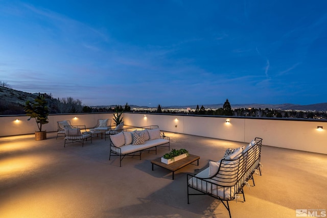 patio terrace at dusk featuring an outdoor living space