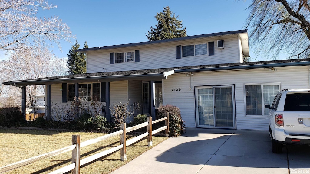 view of front of property with a porch, a front yard, and fence