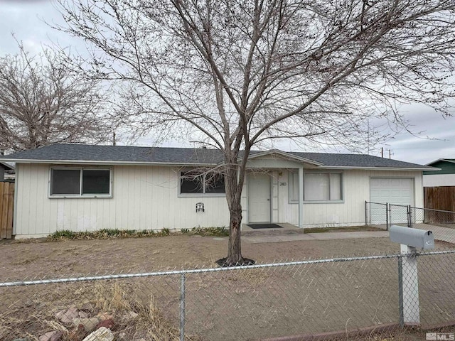 ranch-style house with a garage and fence private yard