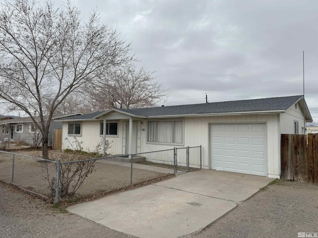 ranch-style home with a garage, a fenced front yard, concrete driveway, and roof with shingles