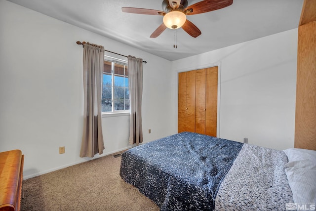 bedroom featuring baseboards, visible vents, a ceiling fan, carpet flooring, and a closet