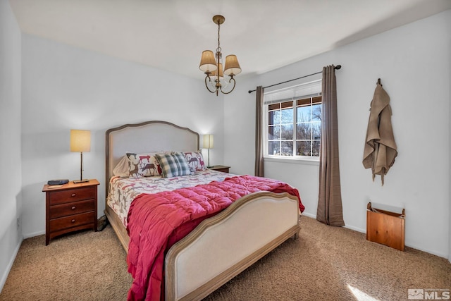 carpeted bedroom with a chandelier and baseboards