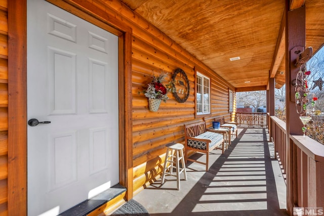 exterior space with a porch and log exterior