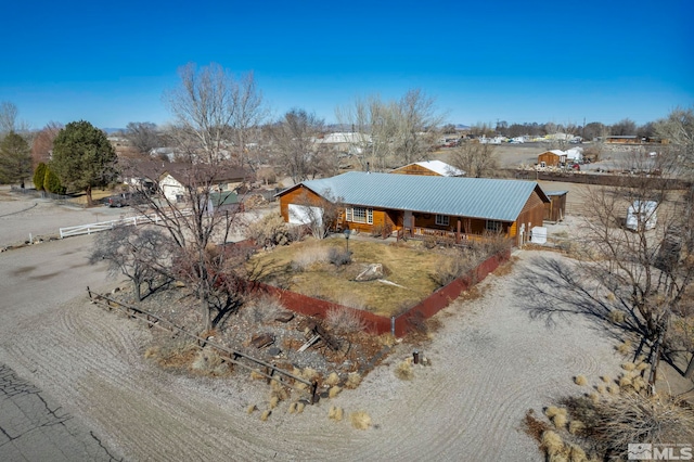 view of front of home with driveway and metal roof