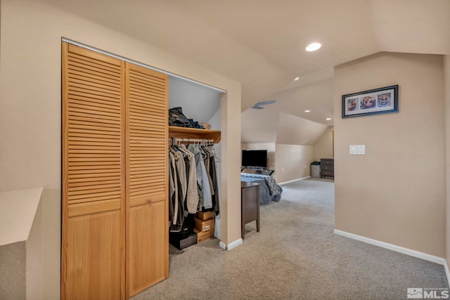 interior space with carpet and vaulted ceiling