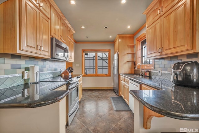 kitchen featuring crown molding, open shelves, stainless steel appliances, a sink, and baseboards