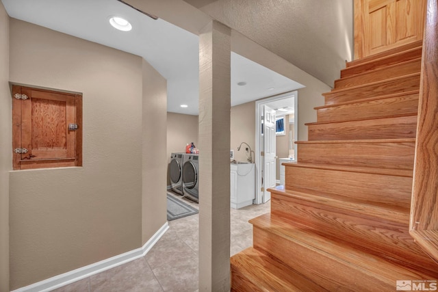 staircase featuring tile patterned flooring, baseboards, washer and clothes dryer, and recessed lighting