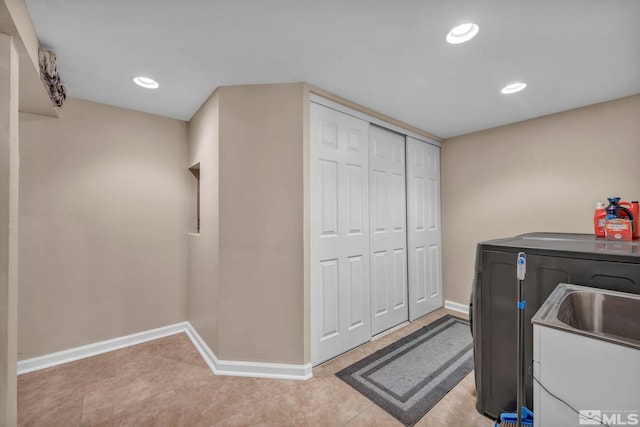 washroom with laundry area, washer and clothes dryer, recessed lighting, and baseboards