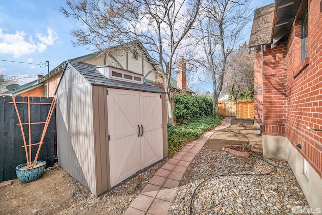 view of shed featuring fence