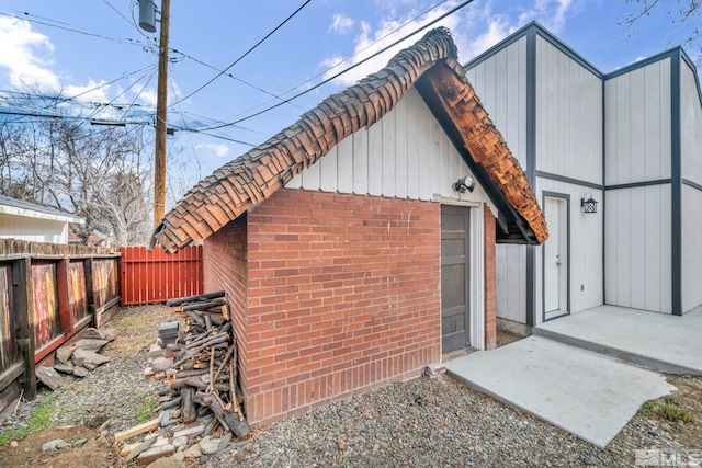 view of outbuilding featuring fence