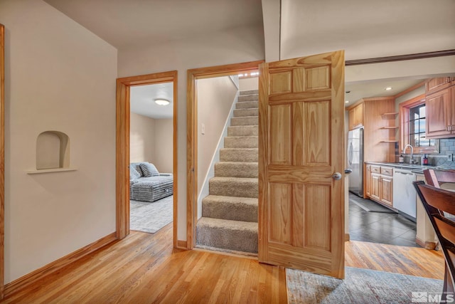 stairway featuring wood finished floors and baseboards