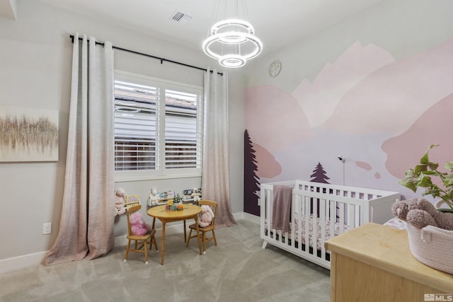 carpeted bedroom with a chandelier, visible vents, a crib, and baseboards