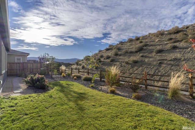 view of yard with a fenced backyard and a mountain view