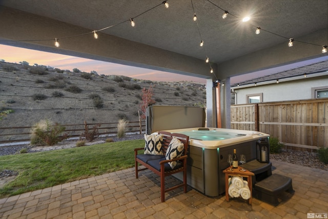 view of patio / terrace featuring a fenced backyard and a hot tub