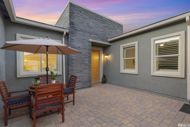 patio terrace at dusk with outdoor dining space