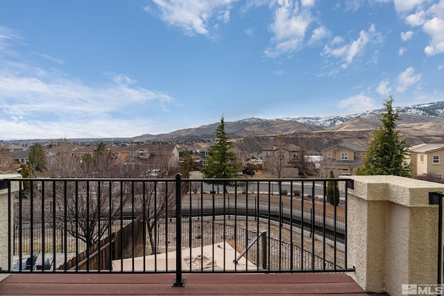 balcony featuring a residential view and a mountain view