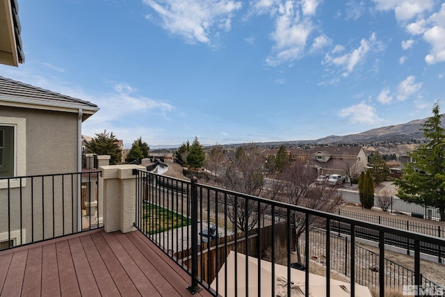 balcony featuring a residential view and a mountain view