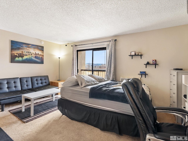 carpeted bedroom featuring a textured ceiling and access to outside