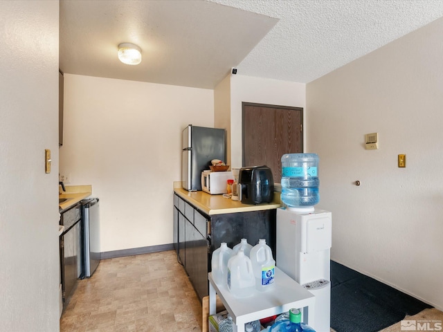 kitchen with dishwashing machine and light countertops