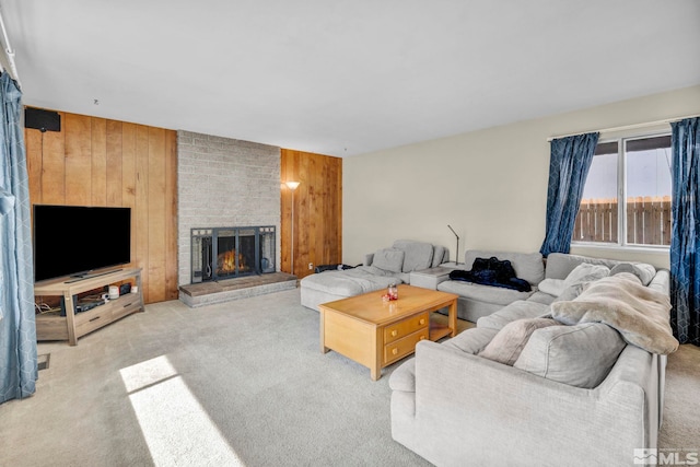 living room featuring light carpet, wood walls, and a fireplace