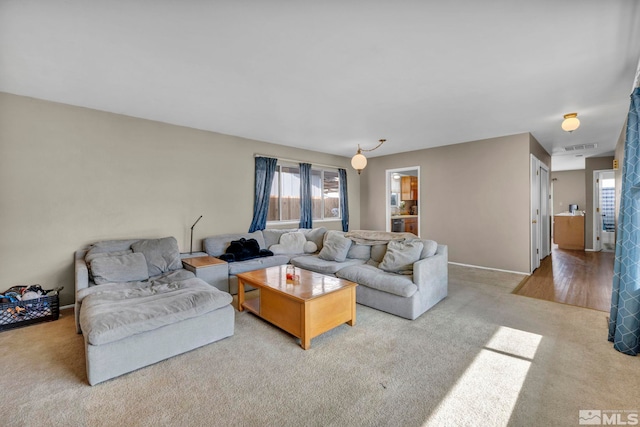 carpeted living area with visible vents and baseboards